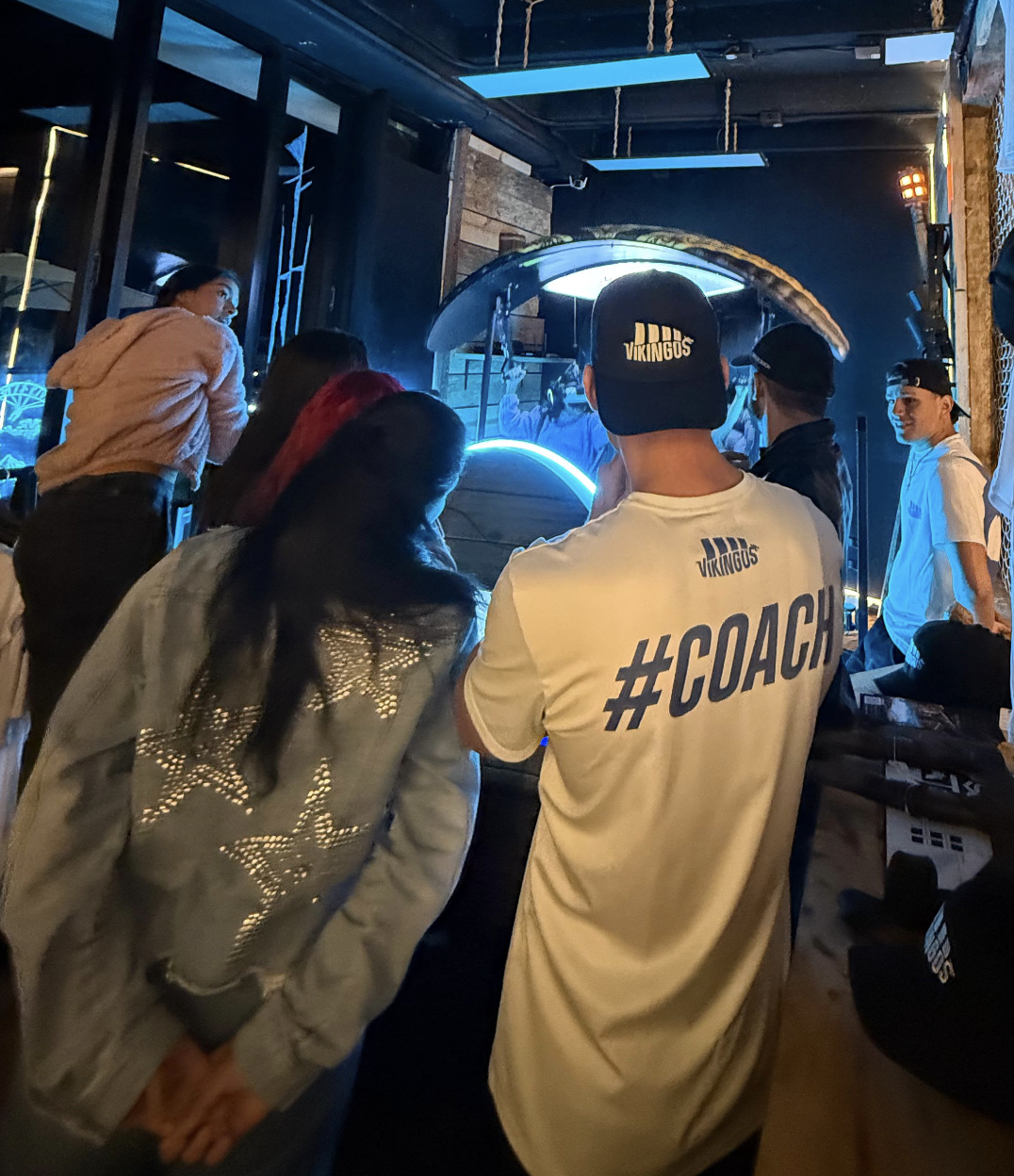 A packed room at Valhalla World gathered around the VR attraction during a group event